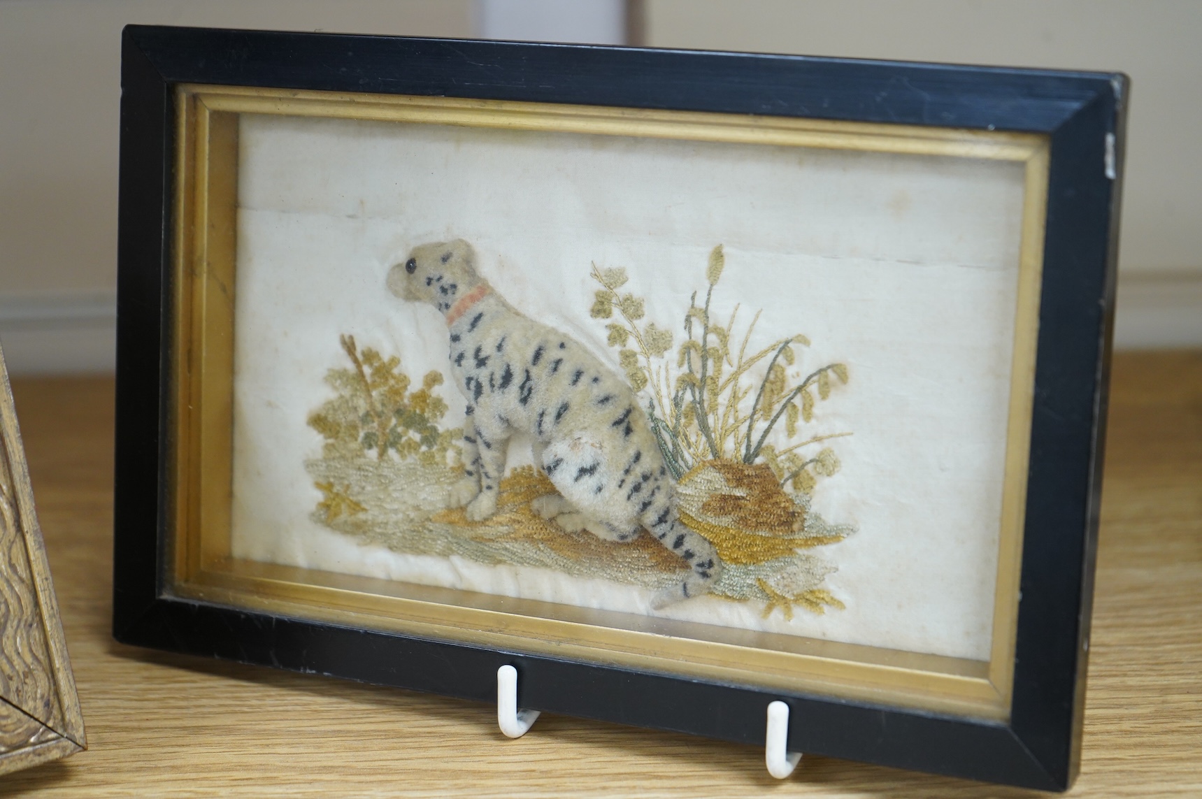 An unusual 19th century stump work needlework embroidery of seated leopard (or dog) in a landscape, together with a smaller petite pointe embroidery of a Spaniel, stump work 17.5cm wide x 9.5cm high. Condition - the back